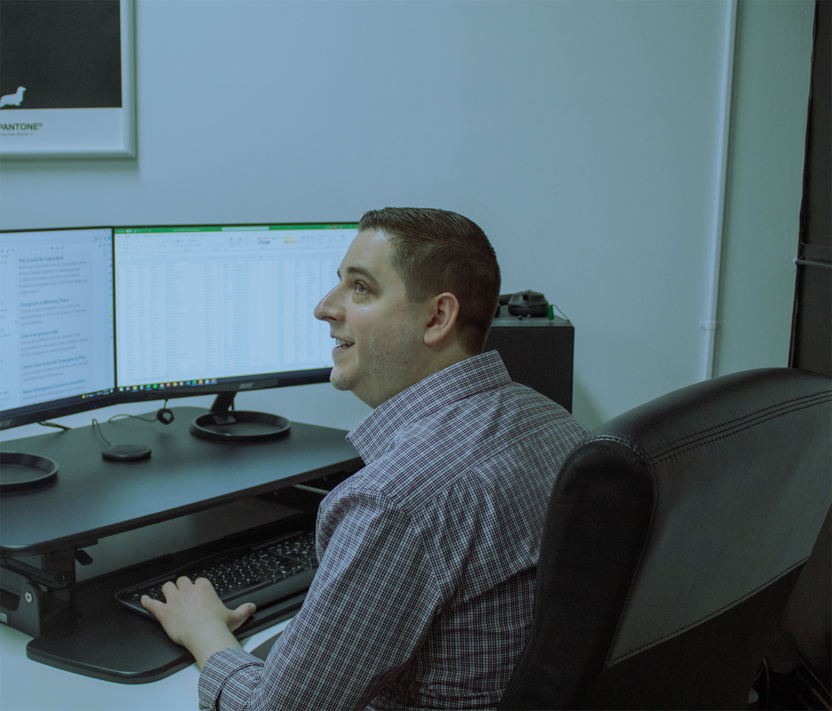 Picture of a man at a computer working on lists and variable data.